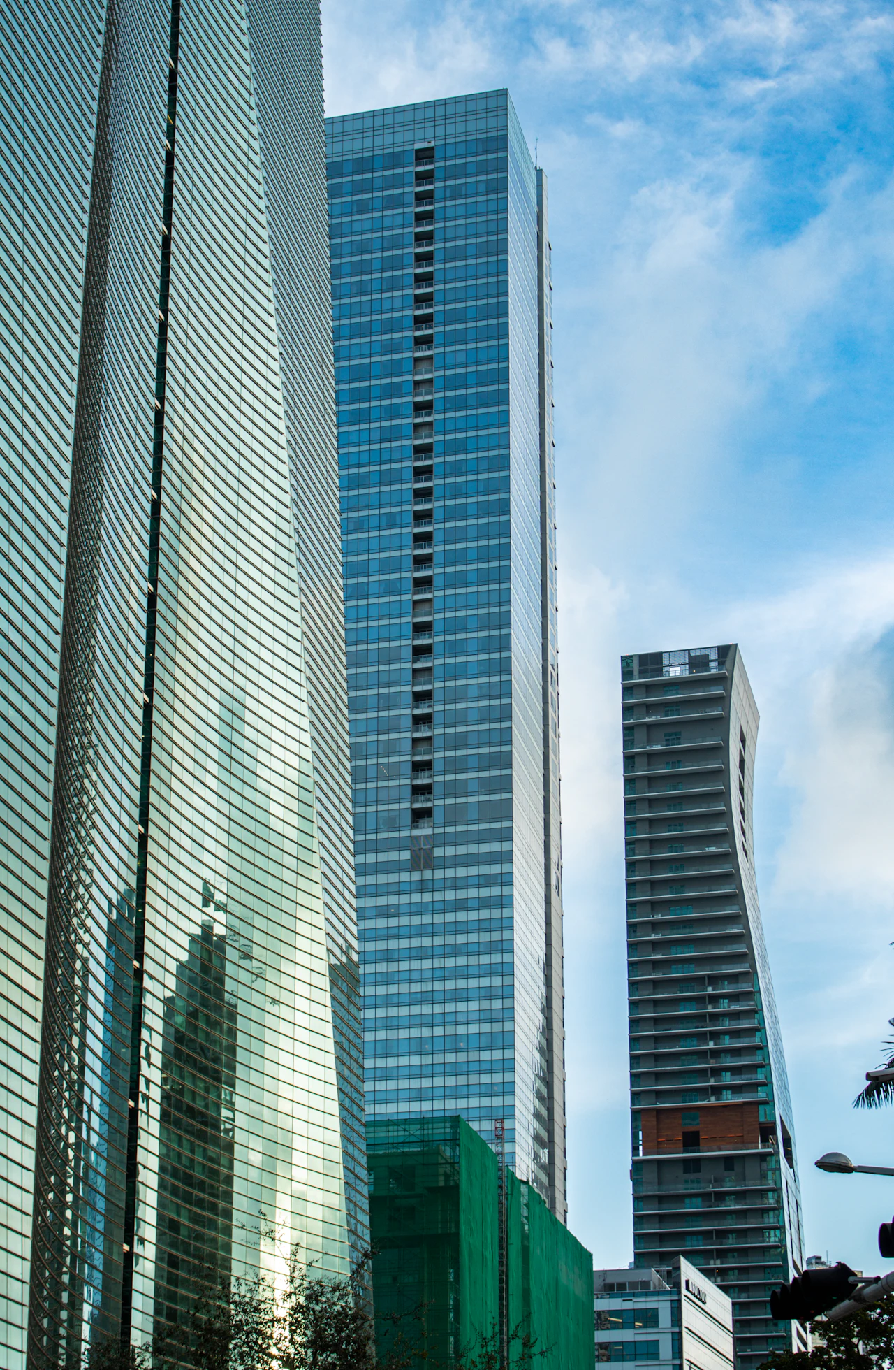 Glass high-rise buildings photographed in Miami against a blue sky